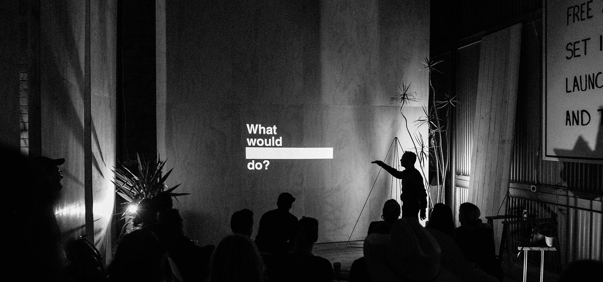 Man gives a talk in front of a sculpture at a Launch Intention Venice International Airport Studio activation.