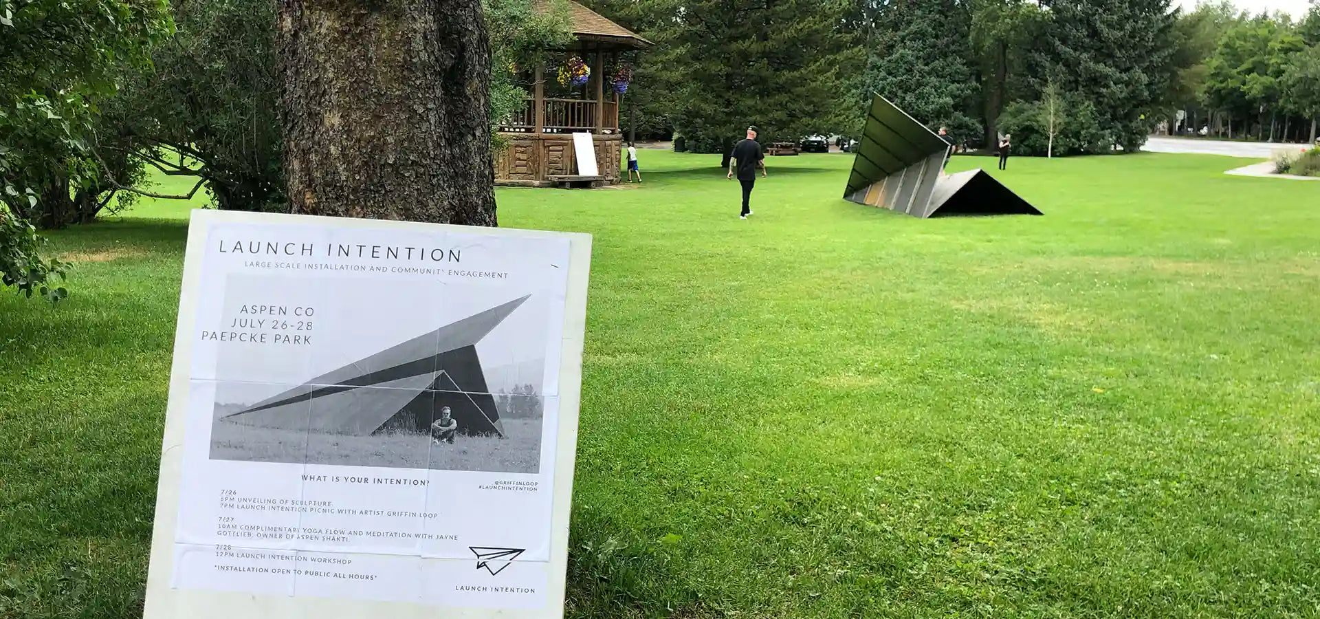 Launch Intention Art installation in Paepcke Park with the activation times and descriptions on a sign in the foreground.