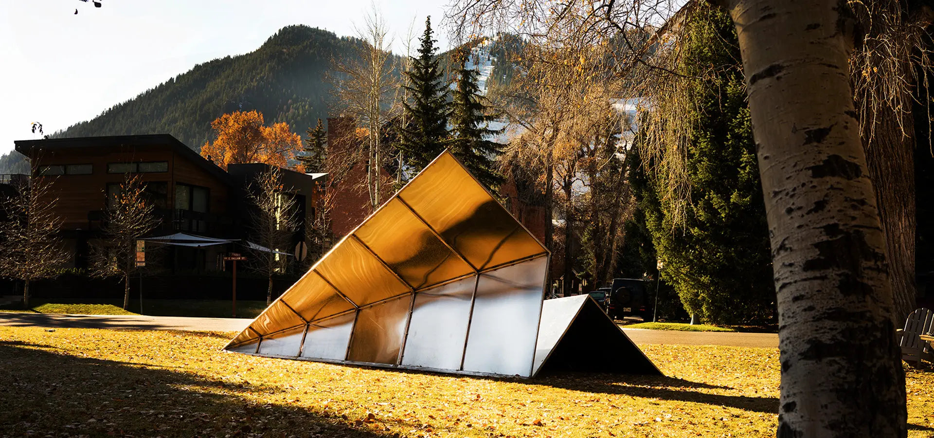 Modern Paper Airplane Sculpture by Launch Intention in Aspen Colorado's beautiful setting with trees and mountains.