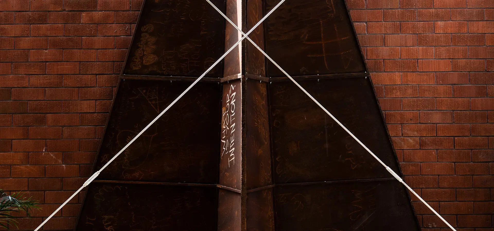 The Launch Intention's Metal Paper Plane sculpture standing upright with "What is your intention" written on the side, inside the VIA studio in Venice Beach, California.