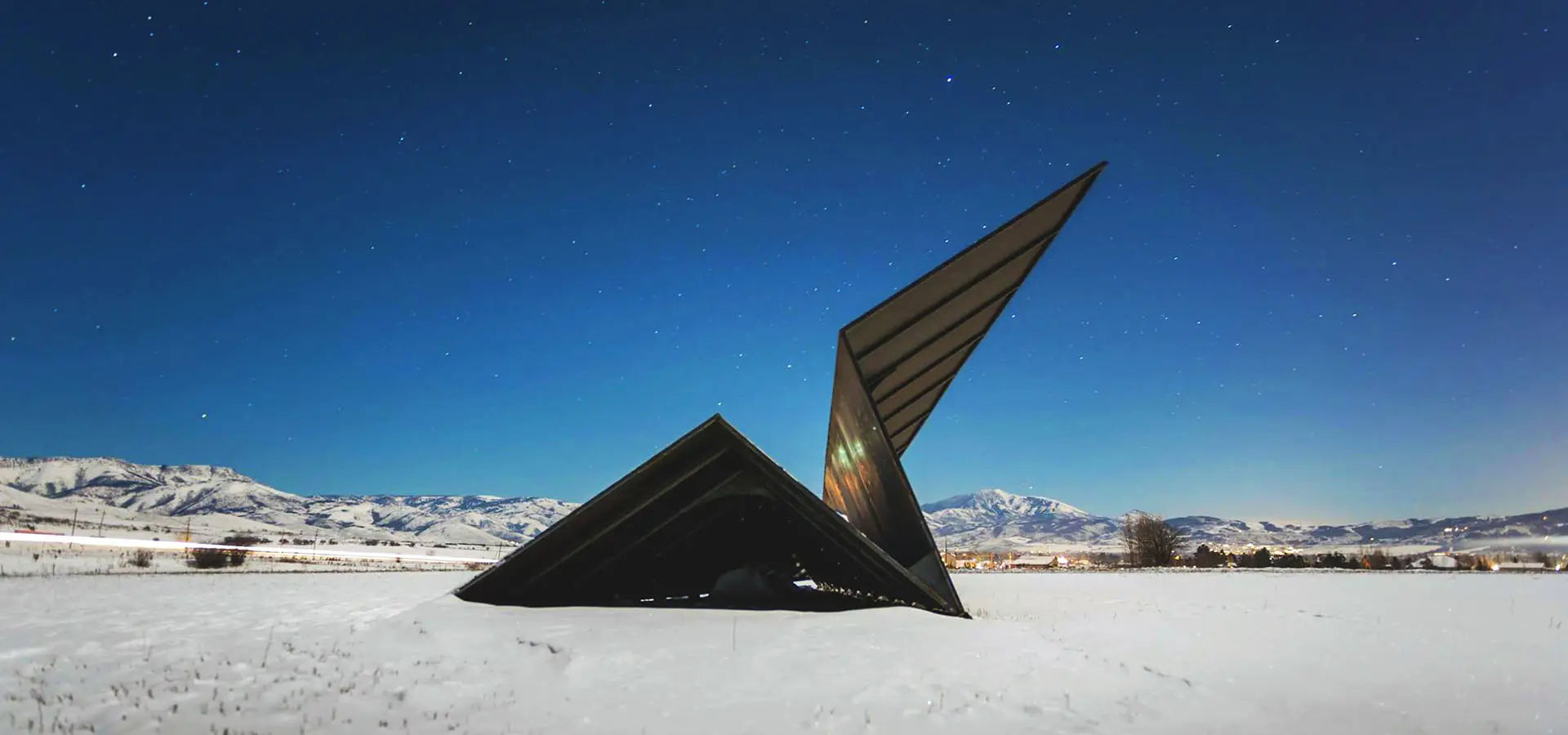 The Original Launch Intention 50 Foot Paper Airplane Sculpture resting in the Eden Valley below the stars and Powder Mountain in the distance.