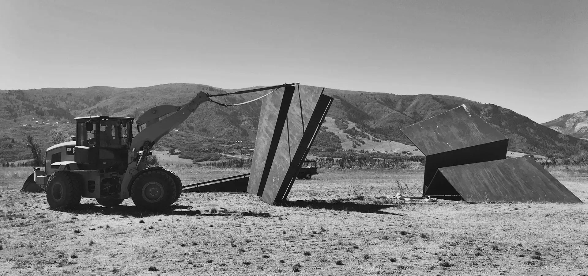 Large tractor building the 50ft Launch Intention metal paper airplane sculpture at Powder Mountain, Ut.
