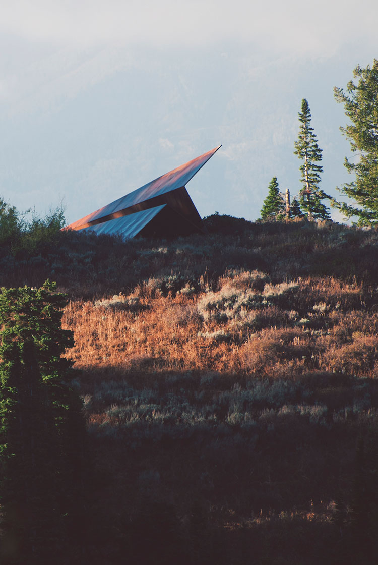 Launch Intention large scale 50 foot paper airplane sculpture sit's atop a ridge at Powder Mountain, Utah surrounded by nature.