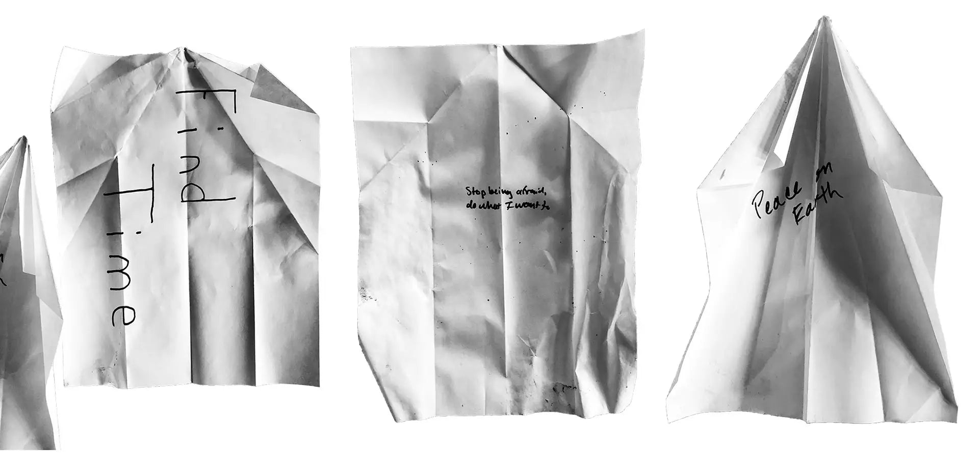 Three folded pieces of paper with handwritten intentions on a white background