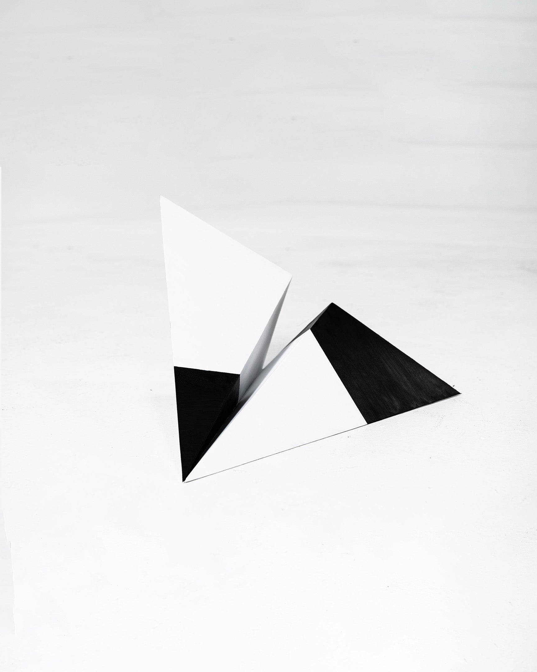 Grey Area 24 inch black and white paper plane sculpture by Griffin Loop
