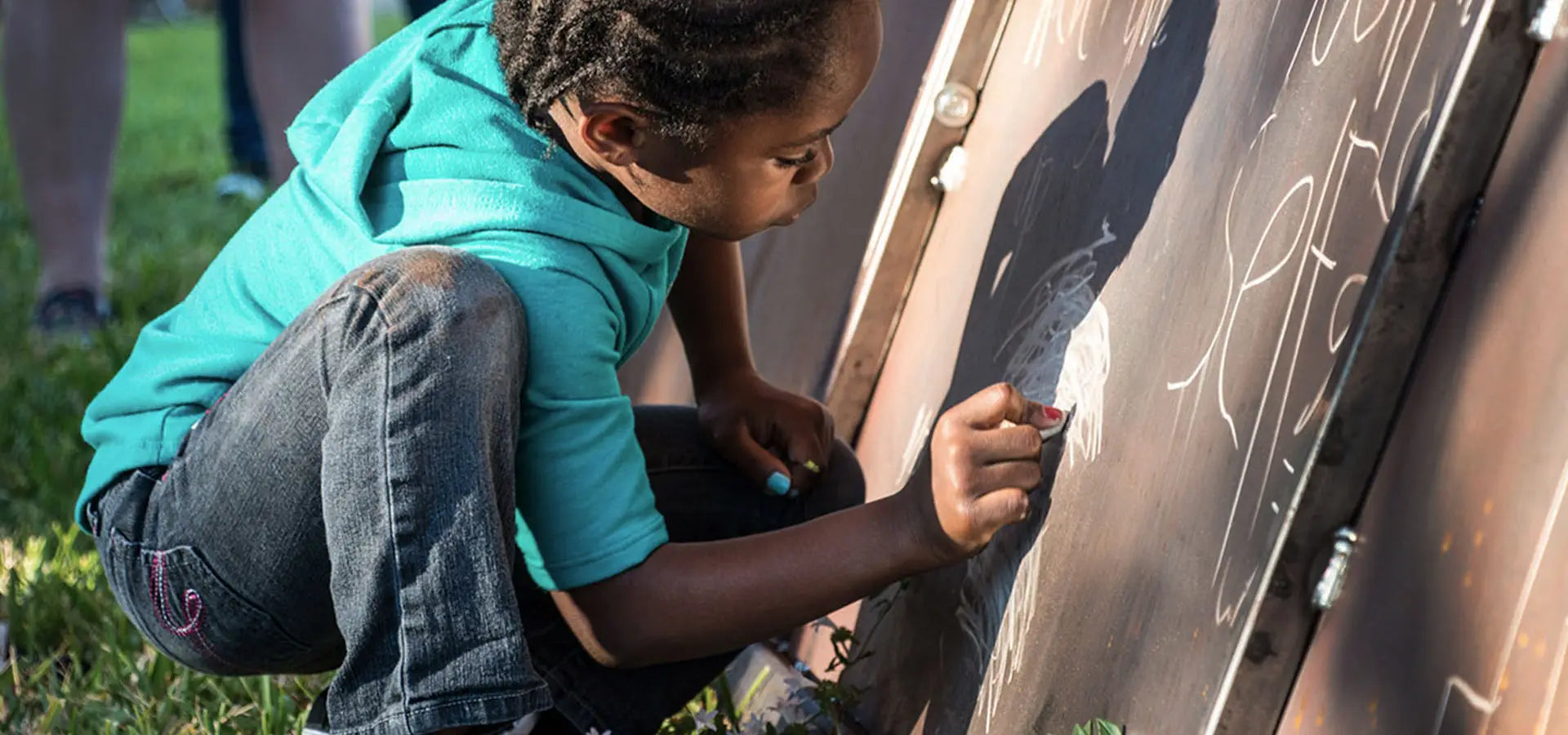Child drawing on a Launch Intention 25ft Paper Airplane Sculpture at the Canvas Outdoor Museum in Palm Beach Florida.