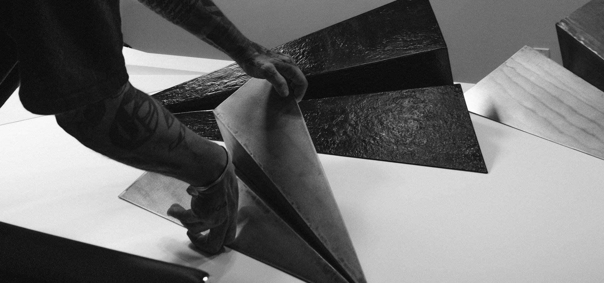 Artist Griffin Loop arranges paper airplane sculptures for Launch Intention's activation at Context Art Miami during Art Basel.