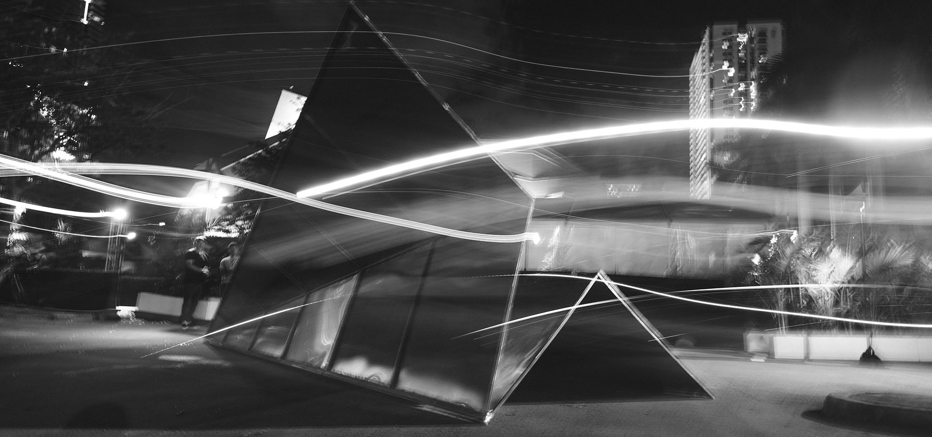 A long exposure of Launch Intention's 25ft Stainless Steel Paper Airplane Sculpture during Art Basel at the Context Art Miami entrance.